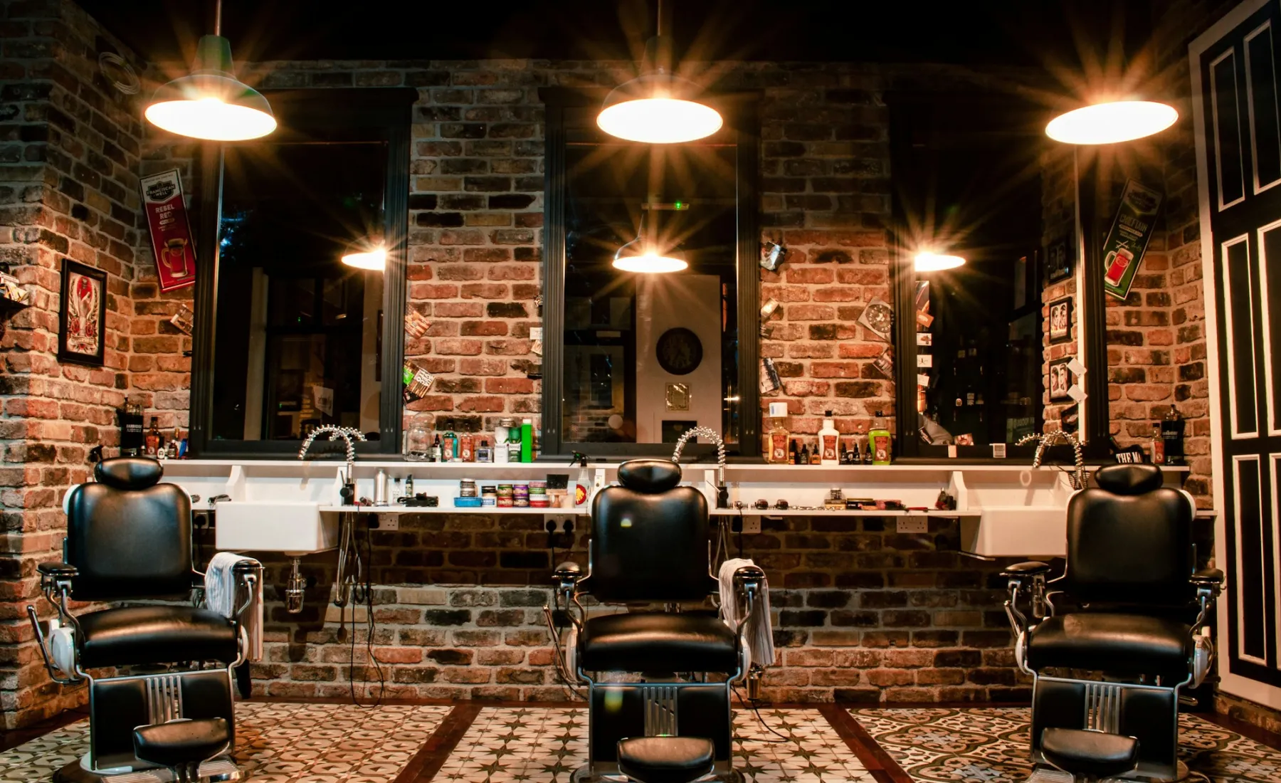 Three barber chairs under warm lights